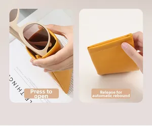 Macro detail of squeezing a yellow PU leather sunglasses pouch with automatic closure