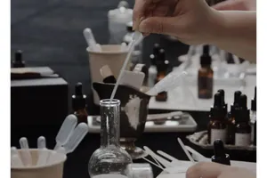 Detailed scene of fragrance crafting process with glass droppers and essential oil bottles