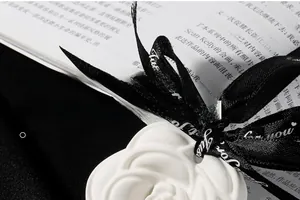 Macro shot of camellia flower scented plaster stone with ribbon hanging on a book