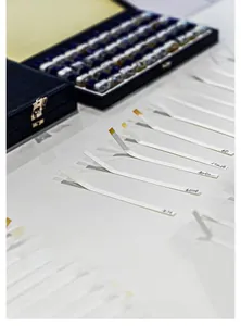 Close-up of fragrance tester set with glass vials, scent strips, and a black storage box