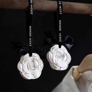 White camellia plaster air freshener with black ribbon for closet and car decor