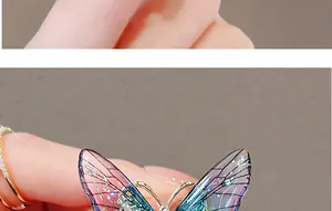 Macro shot of butterfly brooch with blue-purple gradient wings and sparkling silver glitter