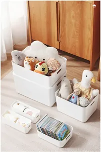 White plastic storage bins in multiple sizes with handles for home organization