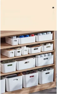 Detail of white plastic storage boxes with handles on wooden shelves for kitchen items