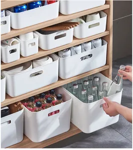 White plastic storage bins with handles in various sizes on wooden shelves for organization