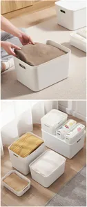 Detail of white plastic storage bins with handles for closet and kitchen organization