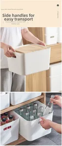 White plastic storage bins with handles showing organized clothing and water bottles