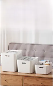 Detailed set of white storage bins with handles for organizing books and snacks