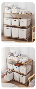 Detail showing various sizes of white plastic storage bins on a wooden shelf in a living room