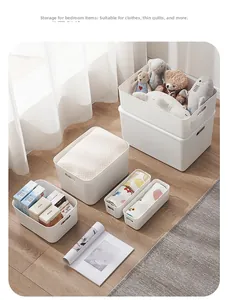 Detail of white storage baskets showing side handles for bedroom and clothes organization