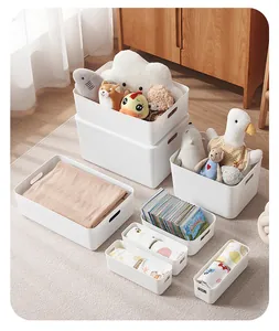 Detailed view of white matte storage bins with oval handles for home organization