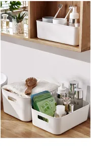 Deep and shallow white plastic storage bins with handles on a wooden shelf