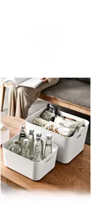 Detail view of white storage bin with hollow handles for easy snacks and bottles organizing