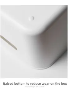 Macro shot of the raised bottom feet on the white plastic storage box to reduce wear