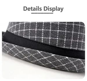 Detail shot of grey plaid fedora hat with elegant black ribbon and fine stitching texture