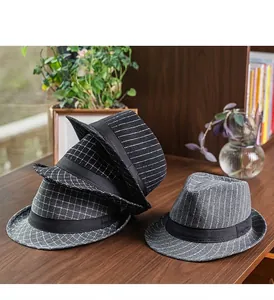 Detail of wool fedora hats in striped and checkered patterns on a wooden surface