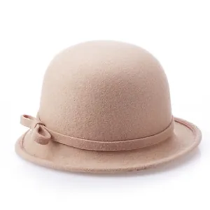 Detailed view of beige wool felt cloche hat with thin band and elegant side bow detail
