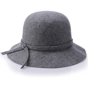 Macro shot of gray wool cloche hat showing fine texture and decorative bow detail