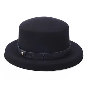 Close-up of black wool fedora with a snowflake cutout leather band and metal buckle