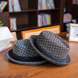 Close-up of retro plaid jazz hats in grey and brown colors on a wooden table
