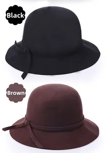 Detail view of wool felt bucket hats in black and brown with decorative bows