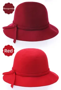 Detail view of wine red and classic red pure wool felt bucket hats with decorative ribbons