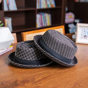 Detail of wool fedora hats featuring vintage plaid and pinstripe patterns on wood desk