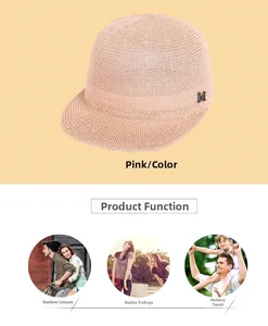 Detail of pink linen straw sun hat featuring a metallic M emblem and outdoor scenes