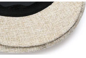Detail of linen flat cap featuring high-quality stitching and a black sweatband