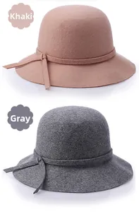 Detail view of khaki and grey wool felt cloche hats showing brim buckle and fine texture