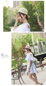 Detail of a light blue striped off-shoulder dress with ruffles and a straw equestrian hat