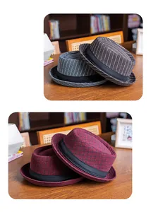Detail of British style fedora hat showing textured plaid wool and black ribbon band