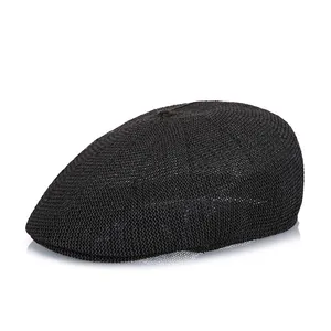 Detail of black woven mesh flat cap showing the breathable texture and top button detail