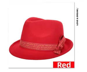 Detail of red wool felt fedora featuring matching ribbon with gold elegant lettering