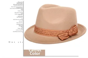 Macro detail of camel wool fedora hat featuring a ribbed ribbon and elegant bow