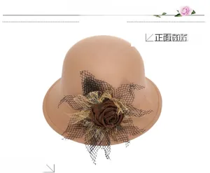 Detail of camel wool cloche hat featuring dark brown satin rose and black mesh veil decor