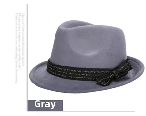 Detailed close-up of grey wool fedora hat with printed ribbon and golden typography