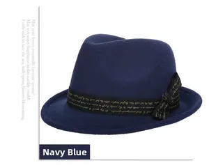 Detail of navy blue wool jazz hat featuring black grosgrain ribbon with gold lettering