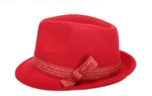 Close-up of a red wool fedora hat with a grosgrain ribbon bow and gold lettering