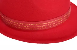 Detail of red wool felt fedora featuring a matching ribbon with gold lettering