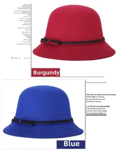 Detail view of burgundy and blue wool cloche hats with black ribbons and bows