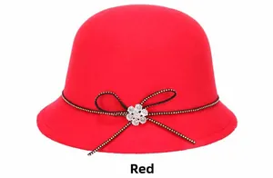 Detail of red wool felt fedora featuring a black bow with a crystal flower ornament