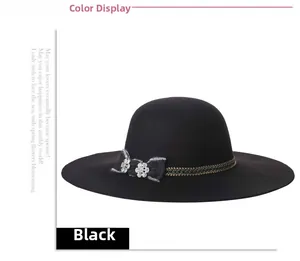 Detail of black wide brim wool hat featuring metal chain, bow and crystal flowers