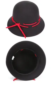 Detail view of black wool felt cloche hat with red cord ribbon and inner sweatband