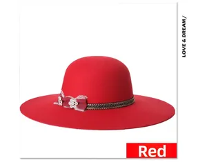 Detail of red wool felt wide brim hat featuring a woven band and crystal flower bow