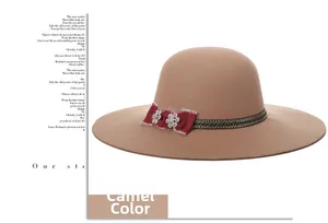 Detail of camel wool fedora hat featuring black ribbon, red bow and rhinestone flowers