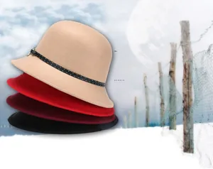 Stack of wool felt bucket hats in beige, red, burgundy and black with decorative bands