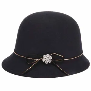 Elegant black wool cloche hat for women featuring golden beads and a rhinestone bow detail