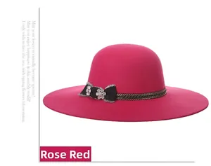 Detail of rose red wool felt fedora with a black bow and sparkling rhinestone flowers