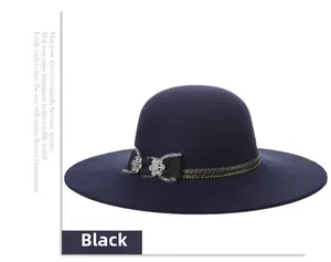 Close-up of black wool fedora featuring lace bow and sparkling rhinestone floral details